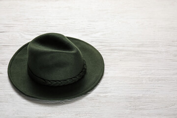 Stylish hat on white wooden background