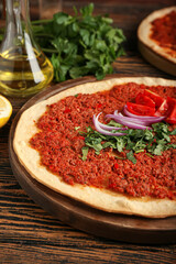 Board with delicious Turkish pizza on table