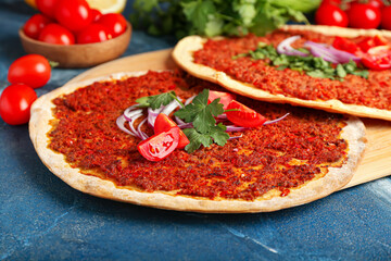 Board with delicious Turkish pizza on color background