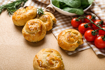 Puff pastry stuffed with spinach and vegetables on color background