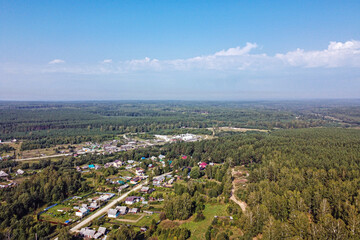 Top view of a small village in the forest on a summer day