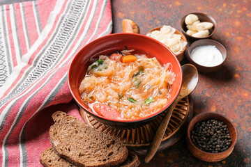 Composition with tasty sauerkraut soup on grunge background