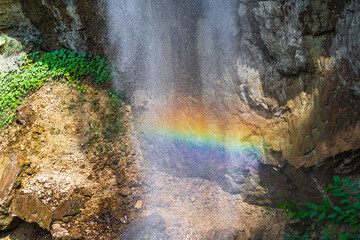Fototapeta na wymiar Rainbow spray in a waterfall