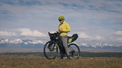 The man travel on mixed terrain cycle touring with bikepacking. The traveler journey with bicycle...