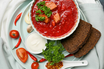 Composition with tasty borscht on light fabric background