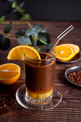 Glass of summer fresh cold sweet bumble cocktail. Double espresso with orange juice and caramel syrup.
