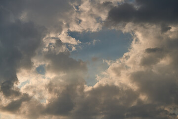 Naklejka na ściany i meble dramatic clouds float across the blue sky