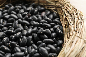 Wicker bowl with raw beans, closeup