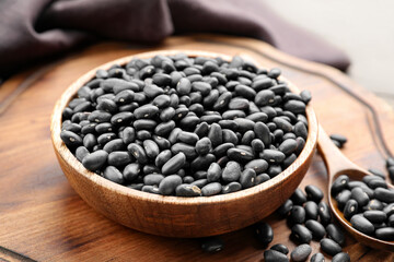 Bowl with raw beans on table