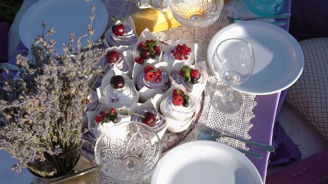 Lavender Tour. Romantic picnic table setting on the lavender field, purple cloth and pillows