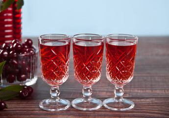 glasses of cherry brandy liqueur with ripe berries