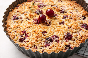 Baking dish with tasty cherry pie on light background, closeup