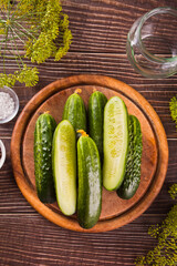 Pickled marinated cucumbers in a kitchen table with dill, spices and garlic
