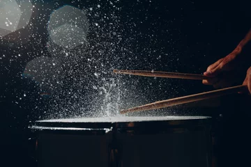 Fotobehang Close up drum sticks drumming hit beat rhythm on drum surface with splash water drops © primipil