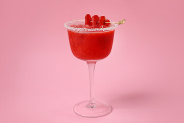 Glass of tasty strawberry margarita on color background
