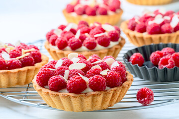 Tartlets with custard and raspberries.