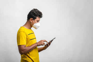 Young indian man using tablet over white background.