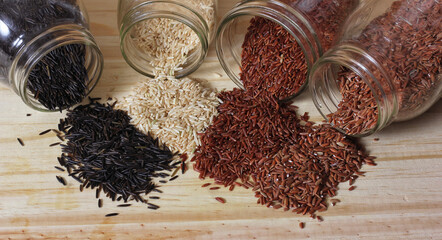 Black Wild Rice on Wooden Table with brown rice and Himalayan red rice