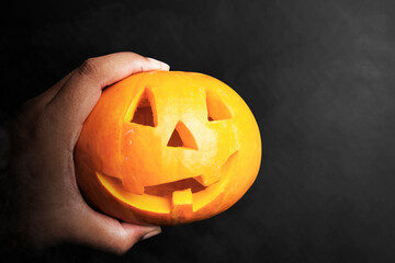 Hand holding Jack-o-Lantern