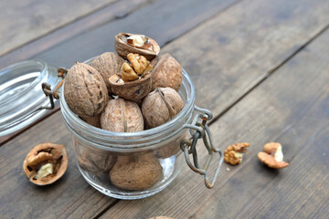 closeup on walnuts in a glass jar on wooden table