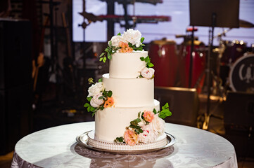 traditional white wedding cake decorated with flowers