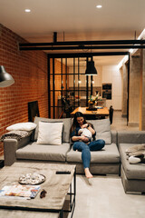 Obraz premium young family at home cuddling while baby is taking a nap