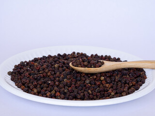 close up of Black pepper on white plate
