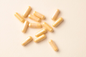 Coenzyme Q10 capsules. Dietary supplements. Bright paper background. Top view. Copy space. 