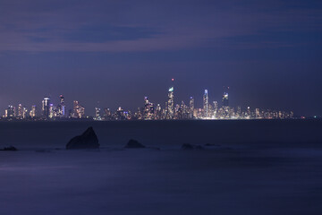 Fototapeta premium Gold Coast cityscape and Currumbin Rock by night