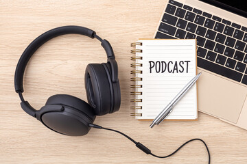 Podcast concept with headphones and laptop on wooden desk