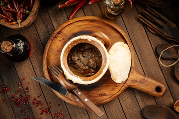 Georgian dish stewed meat chakondrili in a pot with bread