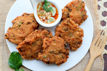 Thai fish cake , in Thai called Tod Mun Pla Krai served with sweet chili sauce 