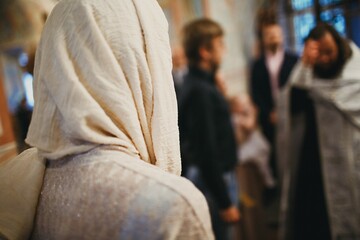 Orthodox Christian priest and parishioner praying in the church