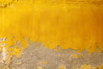 Gold yellow concrete blank wall with peeling paint for colorful vintage background