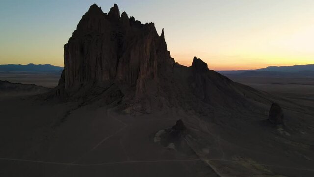 Cinematic aerial shot of iconic monolith in Shiprock in New Mexico