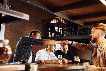 Having fun at weekend. People in casual clothes sitting in the pub