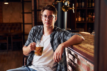 One person. Man in casual clothes sitting in the pub