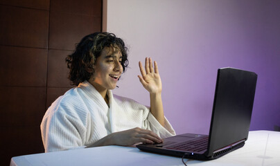 Person waving on laptop