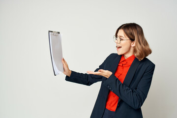 emotional business woman in suit folder with papers manager office light background