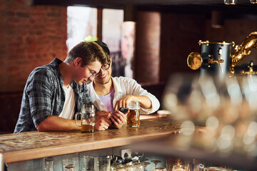 Having fun. People in casual clothes sitting in the pub