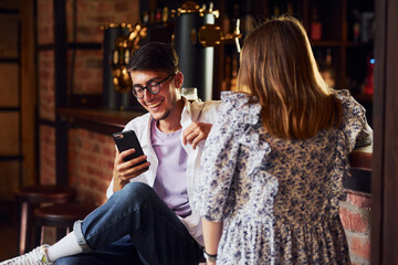 People in casual clothes sitting in the pub