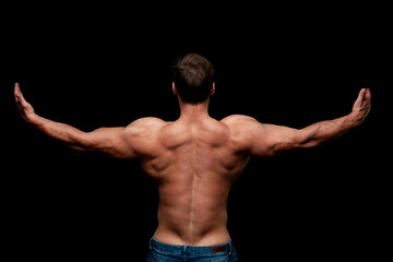 Handsome muscular man, topless, posing in studio. Bodybuilder. Beautiful body. Dark background