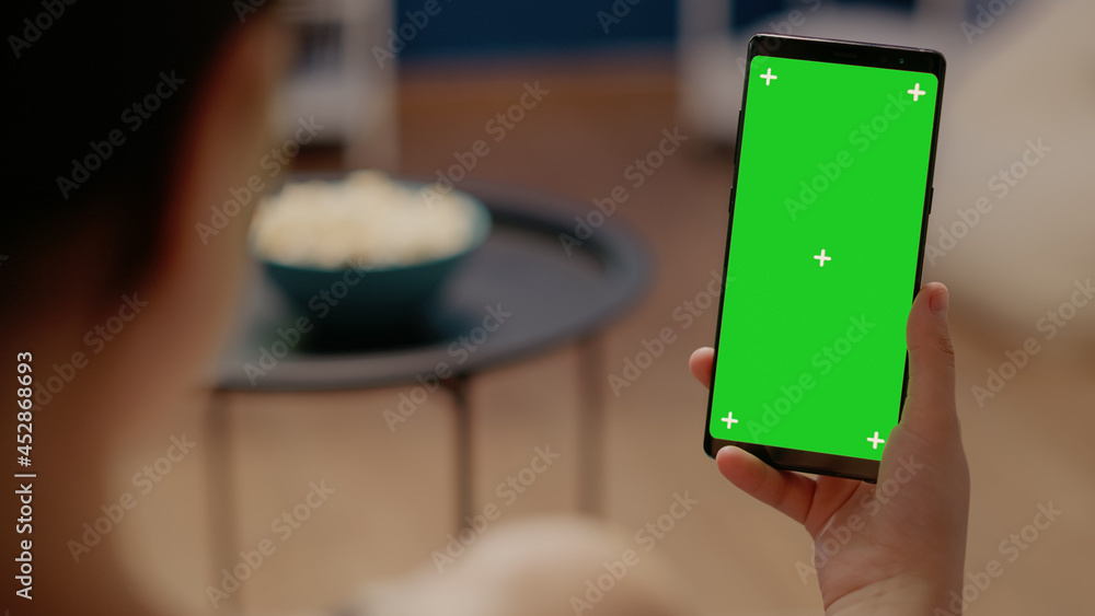 Poster close up on mobile phone with vertical green screen used for modern technology and blank copy space 