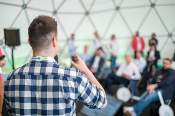 Startup male leader speaks at pitch session