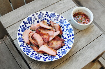 Thai Grilled Pork Neck on blue plate