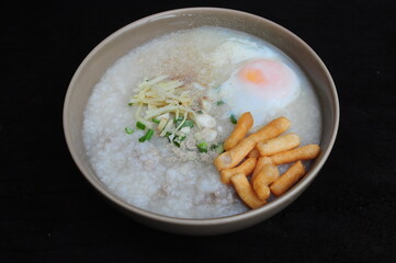 Congee with soft-boiled eggs  in white bowl