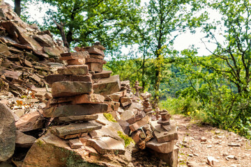 Fototapeta premium Spiel am Wanderweg: Bauen von Steintürmen über der Mosel bei Hatzenport
