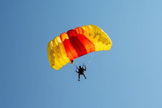 Parachute in the sky. Skydiver is flying a parachute in the blue sky.