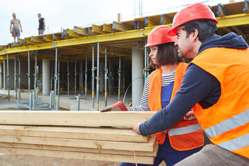 Workers or craftsmen team transports lumber
