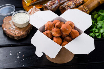 Traditional fried pelmeni, ravioli, dumplings filled with meat on black background, copy space.